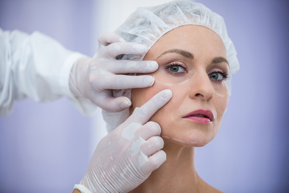 doctor-examining-female-patients-face-cosmetic-treatment_107420-74121.jpg