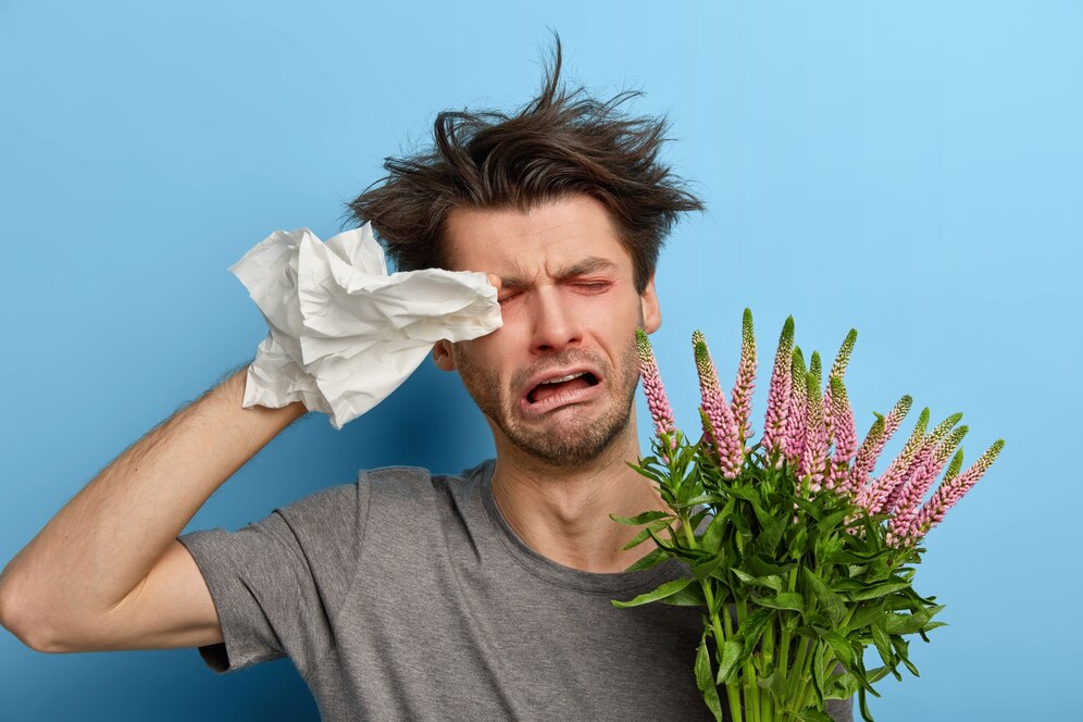 sick-dejected-young-man-rubs-eyes-with-handkerchief-has-allergy-seasonal-flowers-plants-cries-unhappily-being-tired-fighting-against-allergens-needs-good-treatments-stands-indoor_273609-42493.jpg