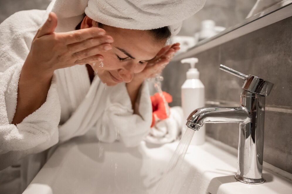 young-beautiful-woman-bathroom-with-towel-her-head-washes-her-face-with-tap-water_169016-10604.jpg