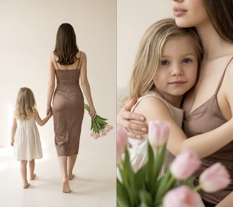 STRICTLY preserve the appearance of the people from the photo 1:1 – retain faces, proportions, age, and natural skin texture. The photo is the reference for appearance.
Vertical 2x2 collage without frames or text.
Bright studio, milky beige background, soft diffused daylight from the left, warm neutral palette, lively depth.
Mother in a fitted coffee-with-milk colored satin dress, thin straps.
Daughter in a light white dress.
Both barefoot.
Pale pink tulips, unwrapped.
FRAME 1 (both in frame): extreme close-up of tulips in hands, but behind the bouquet, both are partially visible – a fragment of mother's décolletage and chin, as well as the lower part of daughter's face and hands, holding the stems together.
FRAME 2: Mother sitting on a light sofa, daughter on her lap, a kiss on the cheek.
FRAME 3: Full height from behind – Mother holding the bouquet in her right hand, her left hand holding the daughter, they walk forward.
FRAME 4: Close-up portrait – daughter embracing mother, bouquet blurred in the foreground.
50mm f/2.0 ISO100 1/320, no HDR or AI-look, maximum photorealism. Aspect ratio 3:4.