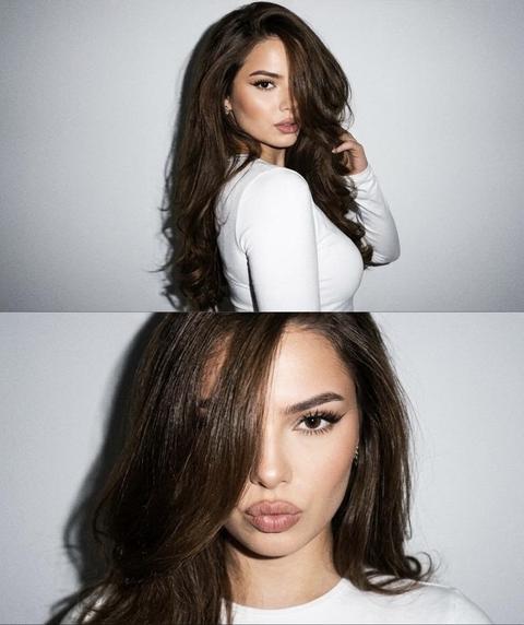 Strictly preserve appearance 1:1 — face, features, proportions, skin texture, and tone without retouching, photo is the reference. 3:4 format. Vertical collage of three horizontal frames, positioned strictly one below the other without gaps or white spaces, a single light-gray background without texture. Y2K digital aesthetic, shot on iPhone with harsh direct flash, hard on-camera flash, sharp shadows behind, slight grain, glamorous atmosphere. Clothing: fitted white long-sleeve top.
1st frame — close-up portrait to the shoulders, very close to the camera, direct sly gaze into the lens, head slightly tilted, index finger near the lower lip, lips relaxed, slightly parted. 2nd frame — medium shot, body in 3/4, head turned towards the camera over the shoulder, voluminous hairstyle partially covering the face. 3rd frame — again a close-up, hair styled to one side covering the left eye, lips in a bow shape, direct gaze. Voluminous brush blow-dry hairstyle, fox eye makeup without altering appearance, accent on the outer corner of the eyes, no AI-look. Background: pure white studio wall.