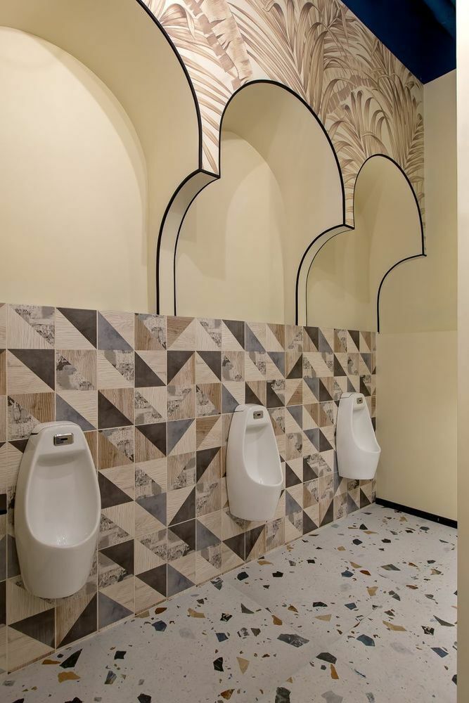 Arched graphics and washroom finishes