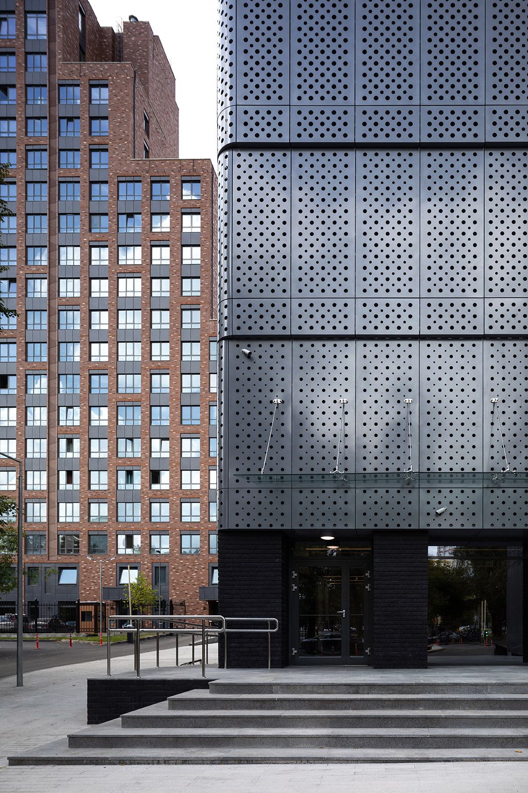 Entrance and the contrast between brick and perforated metal